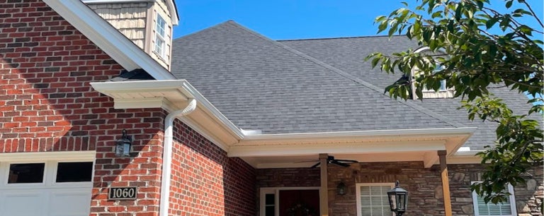 gutters on house and shingle roofs. An example of Twin County Construction roof repair near me, roofing company winston salem